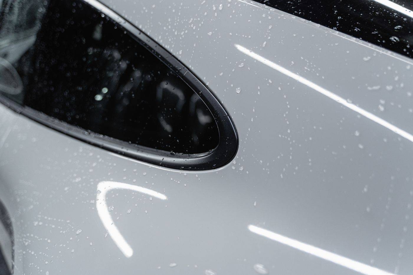 Water beading on a freshly washed white car