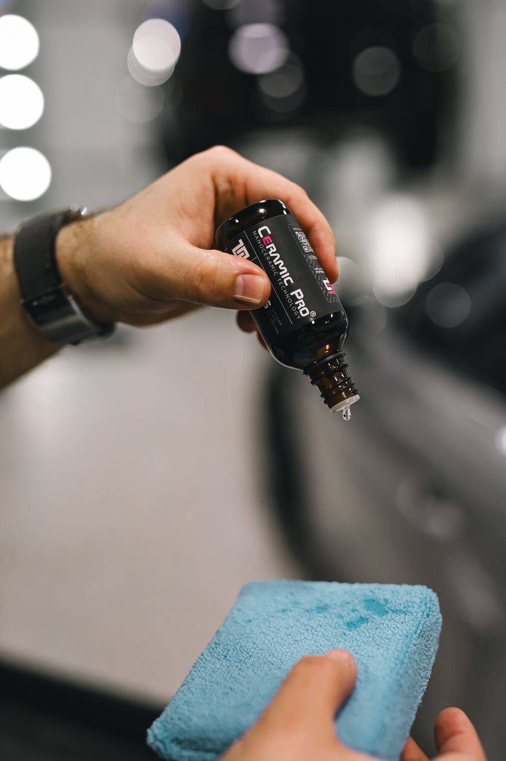 Ceramic sealant being applied to a car panel with a sponge